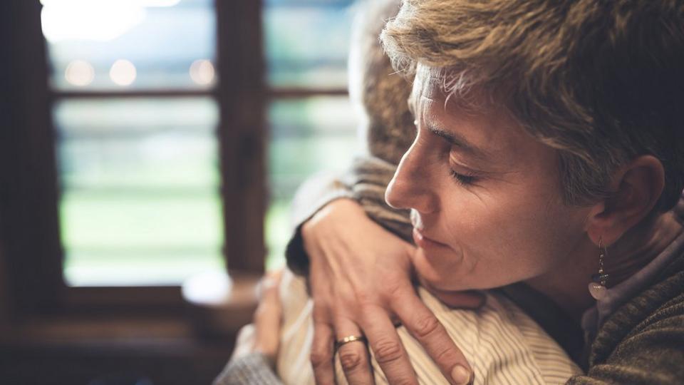 people-giving-tight-hug